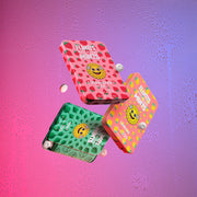 Three Flintts Mints tins — Mint, Lemon, and Strawberry Magic — shown mid-air on a colorful gradient background for the After Party Pack.