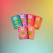 Six Flintts Mints tins in a rainbow arrangement featuring fruity flavors: Cool Watermelon, Strawberry Magic, Luxury Grape, Cherry, Lemon, and Sour Tangerine.