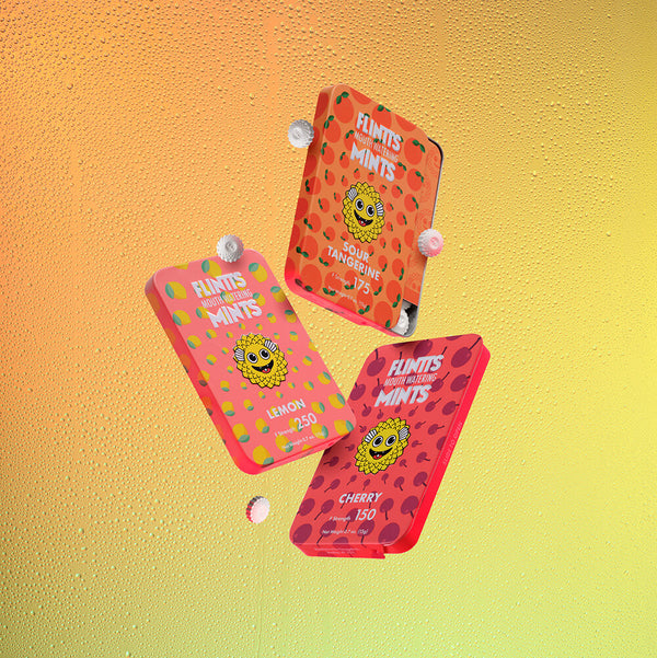 Three Flintts Mints tins — Lemon, Sour Tangerine, and Cherry — arranged on a bright yellow background for the sour-themed variety pack.