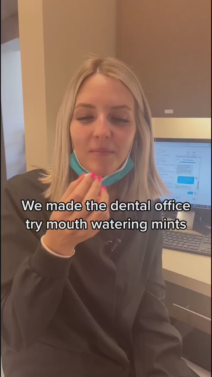 Dental office employee trying Flintts Mints on camera, with visible reaction to the mouthwatering effect.